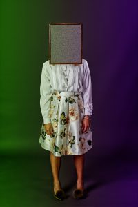 lady with empty picture frame where her face should be